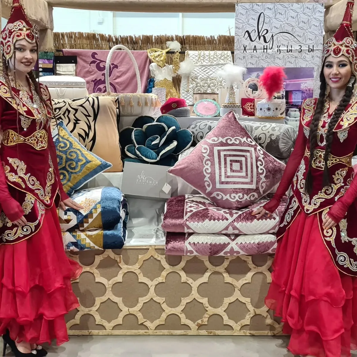 Women in traditional Kazakh dress at a Xan Kyzy exhibition booth