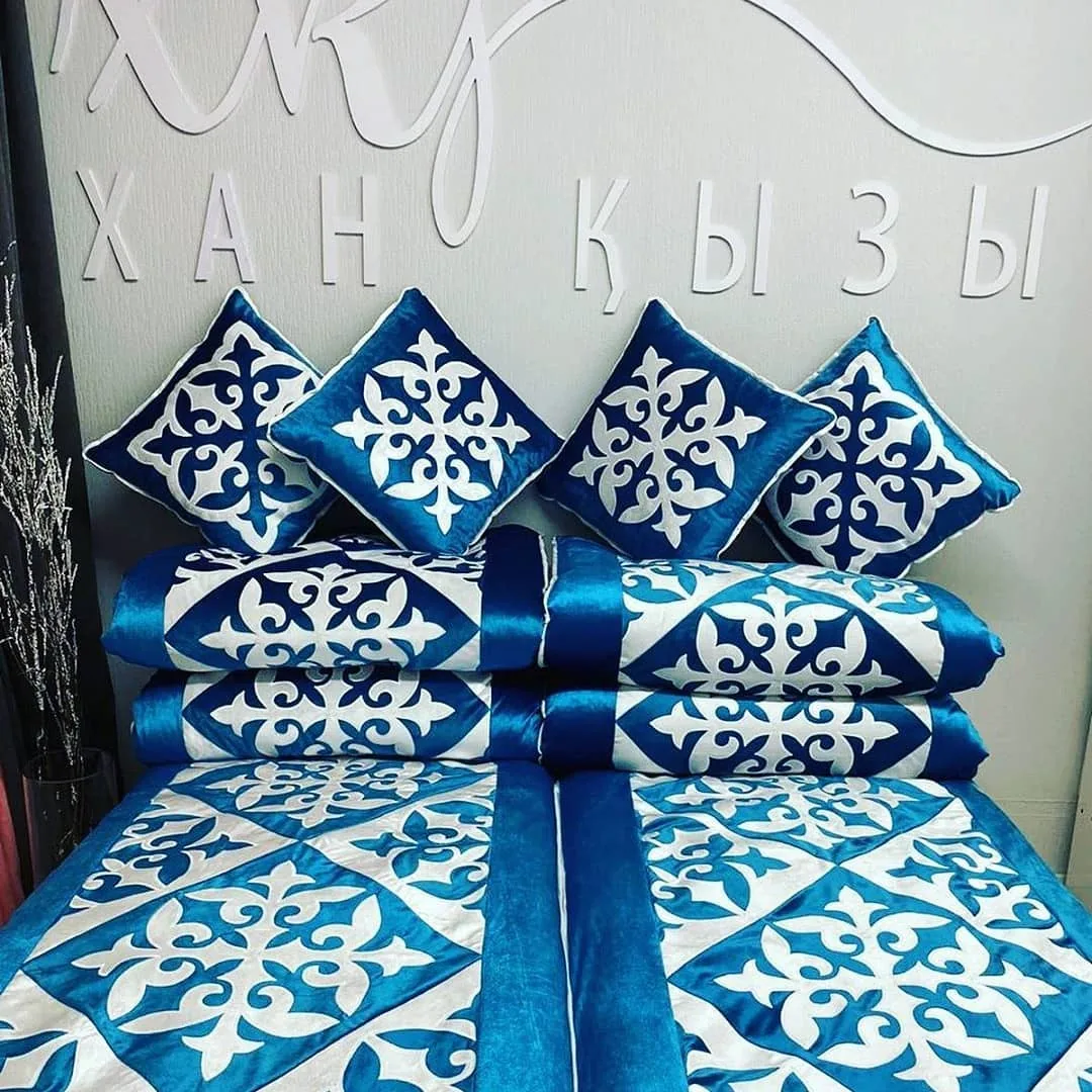 Blue and white ornamental Kazakh cushions styled with a ribbon